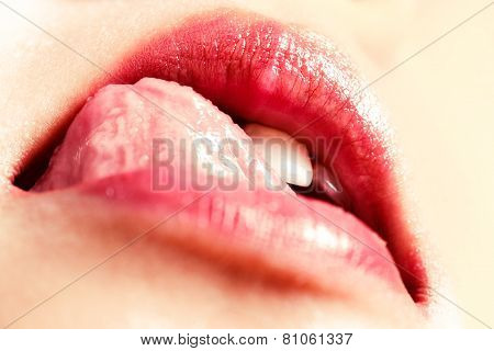 Woman seductively licking lips