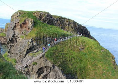 Brave hikers at the Bridge of Rope in Northen Ireland