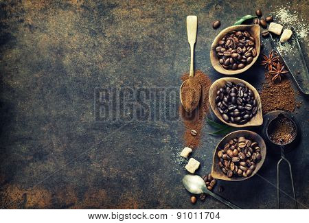 Top view of three different varieties of coffee beans on dark vintage background
