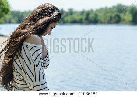 pretty girl on the beach look at water
