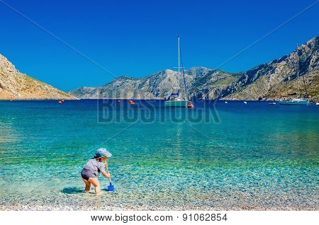 Unidentified child playing at sea bay, Greece