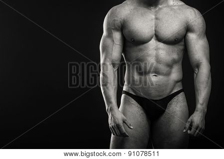 Strong, muscular guy on a black background.
