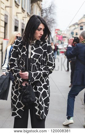 MILAN ITALY - FEBRUARY 25: Fashionable woman poses outside Luisa Beccaria fashion show building for Milan Women's Fashion Week on FEBRUARY 25, 2016 in Milan.