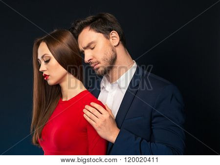 Handsome man embracing attractive woman