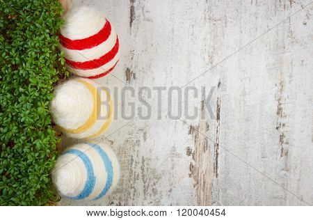 Easter Eggs Wrapped Woolen String And Green Cress On Wooden Background, Copy Space For Text, Decorat