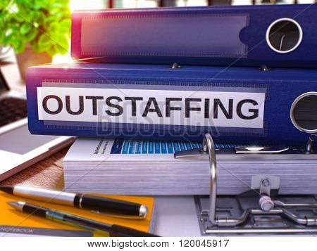 Outstaffing on Blue Ring Binder. Blurred, Toned Image.