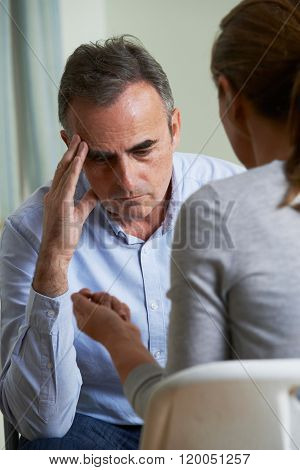 Depressed Mature Man Talking To Counsellor