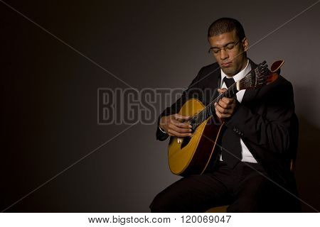 fado musician with a portuguese guitar, studio