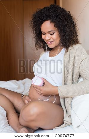 Woman Using A Fetal Doppler At Home