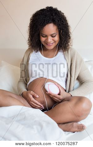 Woman Using A Fetal Doppler At Home