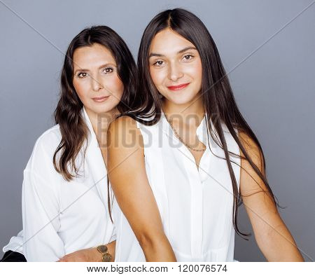 cute pretty teen daughter with mature mothr hugging, fashion style brunette