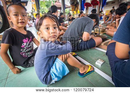 UBUD, BALI / INDONESIA - MAR 1, 2016: Unidentified children at the time of preparations for Ngrupuk parade, which takes place on the eve of Nyepi day in Bali. Nyepi is a public holiday in Indonesia.