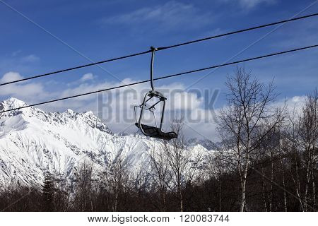 Chair Lift In Snowy Mountains At Nice Day