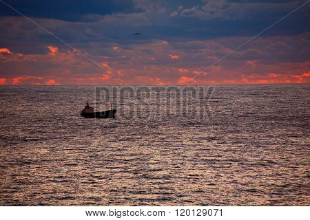 Ship on sunrise sea