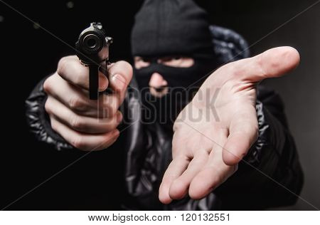Robber with a gun in a mask