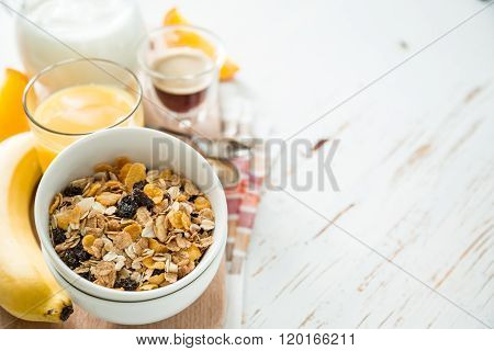 Breakfast - muesli and fruits on white background