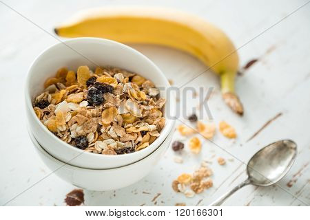 Breakfast - muesli and fruits on white background
