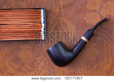 Luxury tobacco pipe on the wooden table