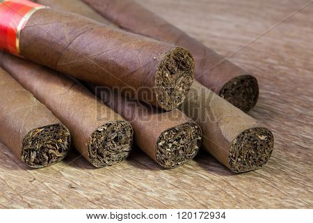 Different Cigars On The Old Wooden Table