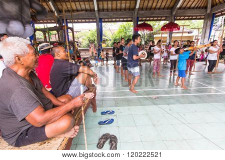 UBUD, BALI / INDONESIA - MAR 1, 2016: Unidentified teenagers at the time of preparations for Ngrupuk parade, which takes place on the eve of Nyepi day in Bali. Nyepi is a public holiday in Indonesia.