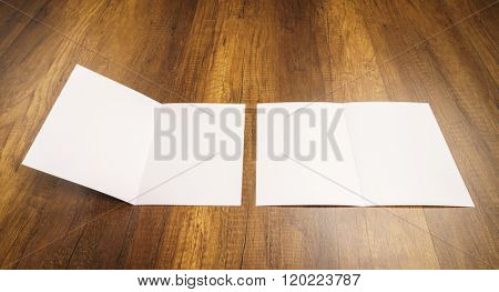 Bifold white template paper on wood texture