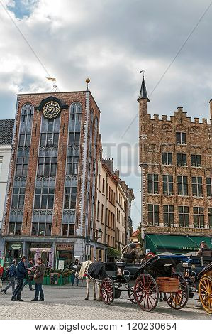 Horse-drawn Carriage With Tourists In Grote Markt, Bruges, Belgium