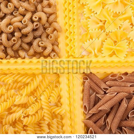 Assortment of italian pasta four different varieties separated with curly spaghetti. Raw pasta texture background.