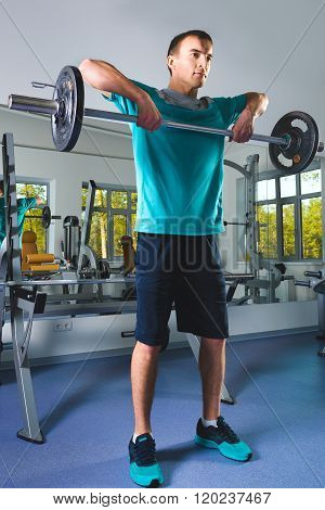 Muscular Man Lifting Deadlift In The Gym
