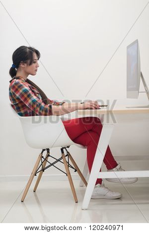 startup business, woman  working on dektop  computer at creative modern office relaxing and have fun