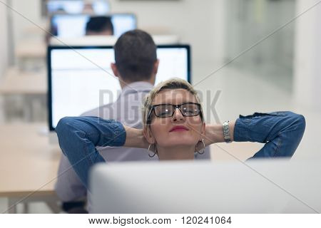 startup business, woman  working on dektop  computer at creative modern office relaxing and have fun
