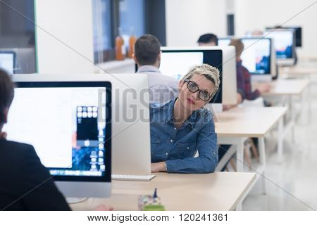startup business, woman  working on dektop  computer at creative modern office relaxing and have fun