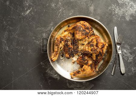 Chicken Tabaka, Flattened And Grilled On Charcoal, Flattened Chicken - On A Metal Tray And Black Boa