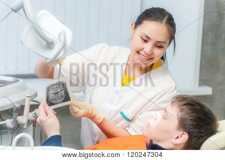 Dentist showing x-ray to a patient