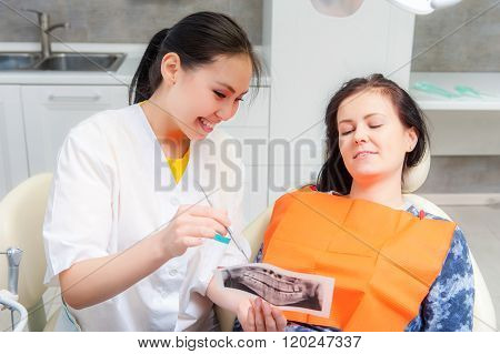 Dentist showing x-ray to a patient