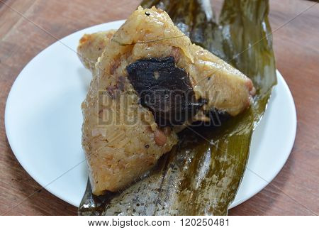 sticky rice steamed with pork and salt egg in banana leaf of Chinese Duanwu festival