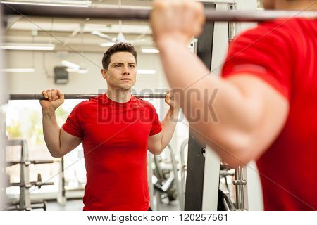 Man Doing Squats On A Smith Machine