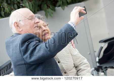 elderly couple taking selfie