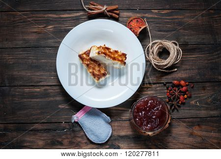 Berry drink. Kissel in glasses with cheese casserole and spices on wood