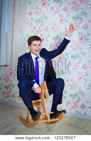 Childish businessman with toy horse