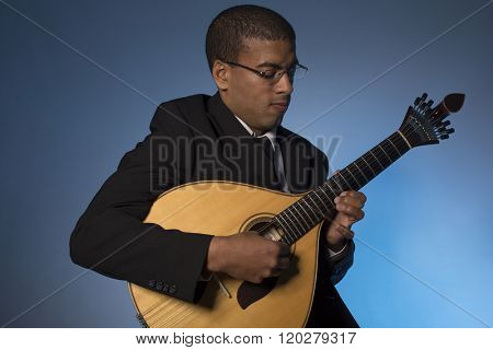 fado musician with a portuguese guitar, studio