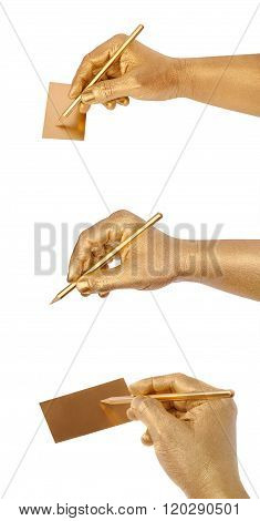 Man's golden hand writes on card by a pencil