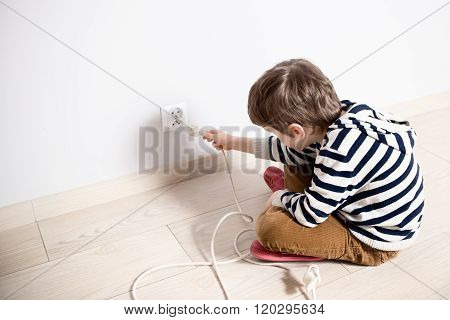 Curious Little Boy Playing With Electric Plug.