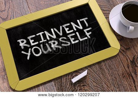 Handwritten Reinvent Yourself on a Chalkboard.