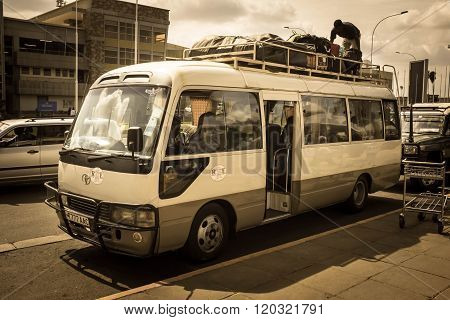 Nairobi, Kenya - January 14:  An Unidentified Driver On The Bus Roof Packs Luggage On January 14, 20