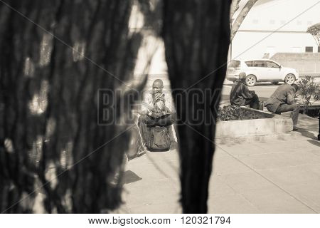 Nairobi, Kenya - January 14:  Three Unidentified  Men Wait On The Bus Station On January  14, 2016 I
