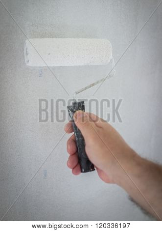 Little cute boy painting on a wall