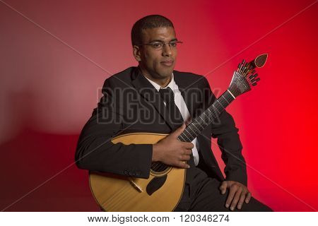 fado musician with a portuguese guitar, studio
