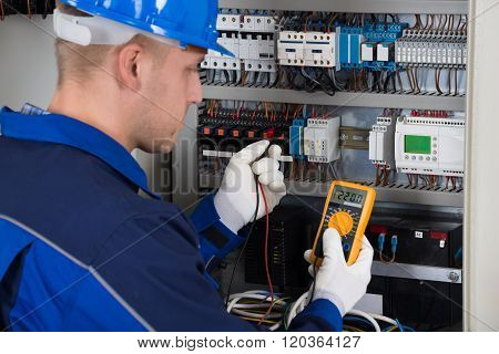 Male Technician Examining Fusebox