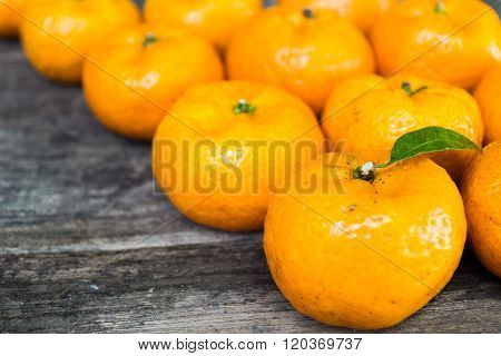 freshy tangerine orange-colored citrus fruit on the wooden table