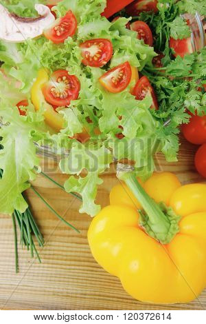 fresh salad and cherry's on wooden table